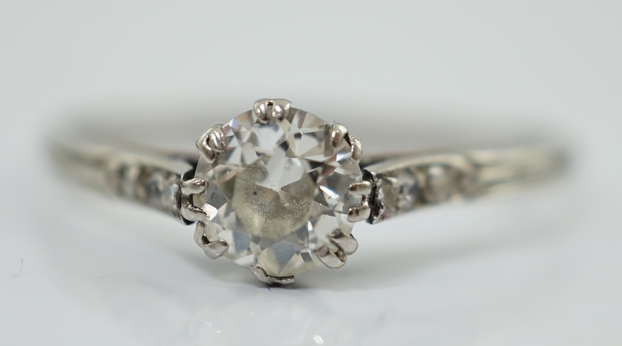A platinum? and single stone diamond set ring, with six stone diamond chip set shoulders